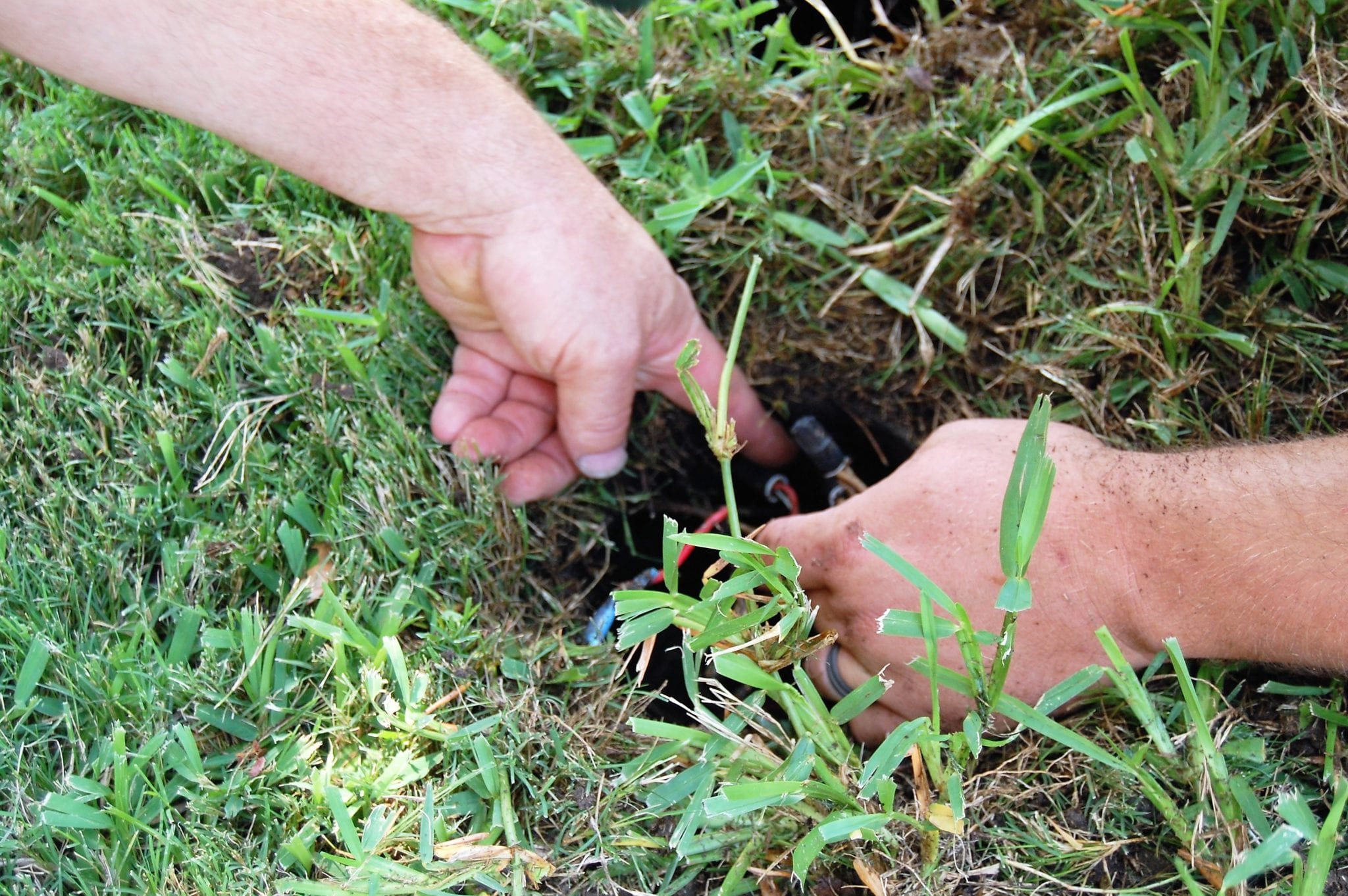 Digging in the yard for Sprinkler Repair in Irving, Texas | H2O Sprinkler Systems
